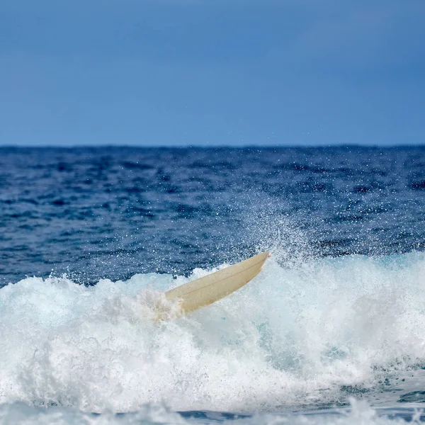 Fall off the Board. surfing board in the air after falling a wav