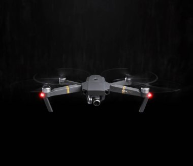 DJI Mavic Pro drone - Flying in the dark, on black background. clipart