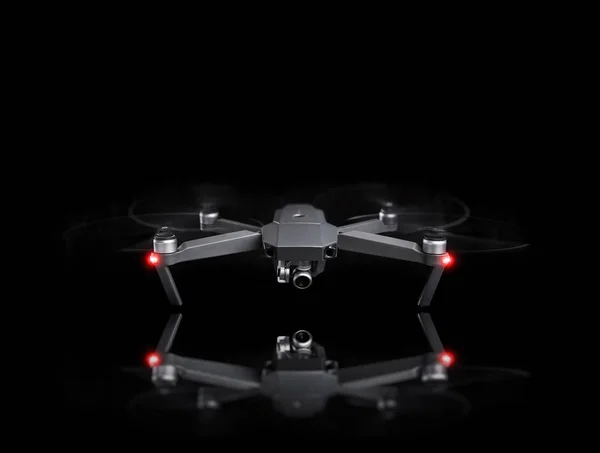 Drone - Flying in the dark, on a black background.