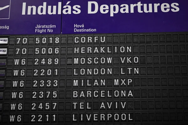 Departures board at the airport. Flight information mechanical timetable. Split flap mechanical departures board. Flight schedule