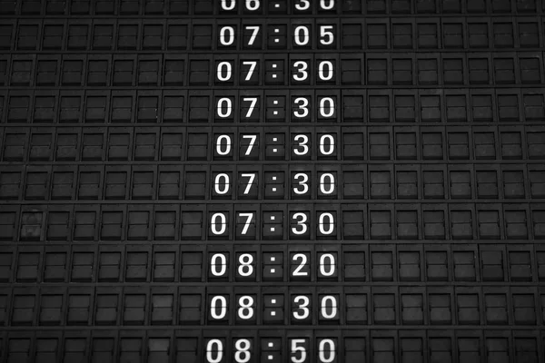 Time boards at the airport. Flight information mechanical timetable. Split flap mechanical departures board. Flight schedule