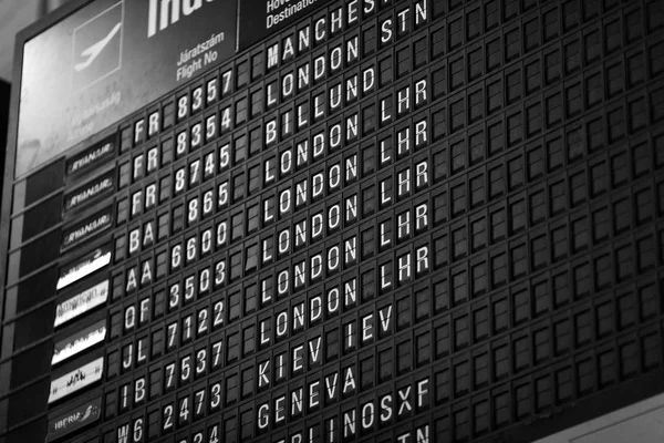 Departures board at the airport. Flight information mechanical timetable. Split flap mechanical departures board. Flight schedule