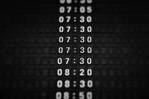 Time boards at the airport. Flight information mechanical timetable. Split flap mechanical departures board. Flight schedule