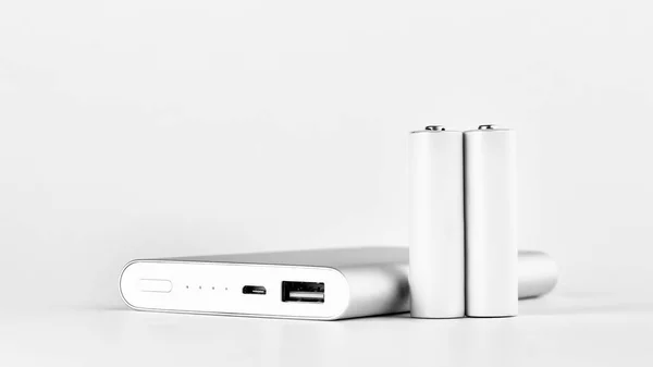 Portable power bank for charging mobile devices and AA batteries — Stock Photo, Image