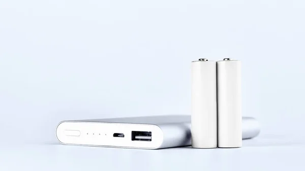 Portable power bank for charging mobile devices and AA batteries. — Stock Photo, Image