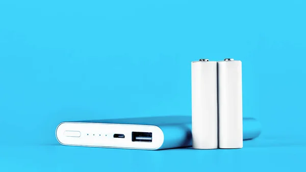 Portable blue power bank for charging mobile devices and AA batteries. — Stock Photo, Image