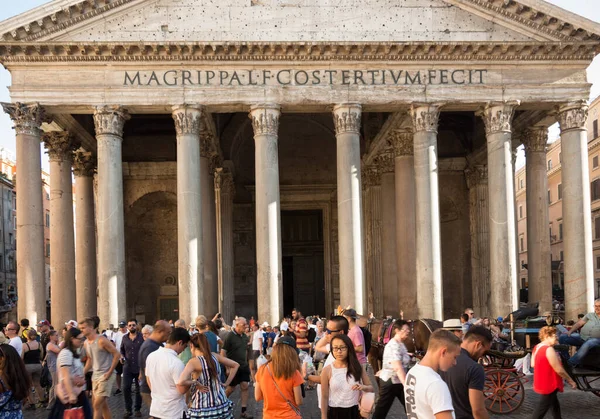 Rome, Lazio/Italy - August 13, 2017: A croud of European and Asian tourists infront of Pantheon. Young Chinese tourist looking at the camera. Summer. Italy tourism. Italy economy. Tourism crisis. 