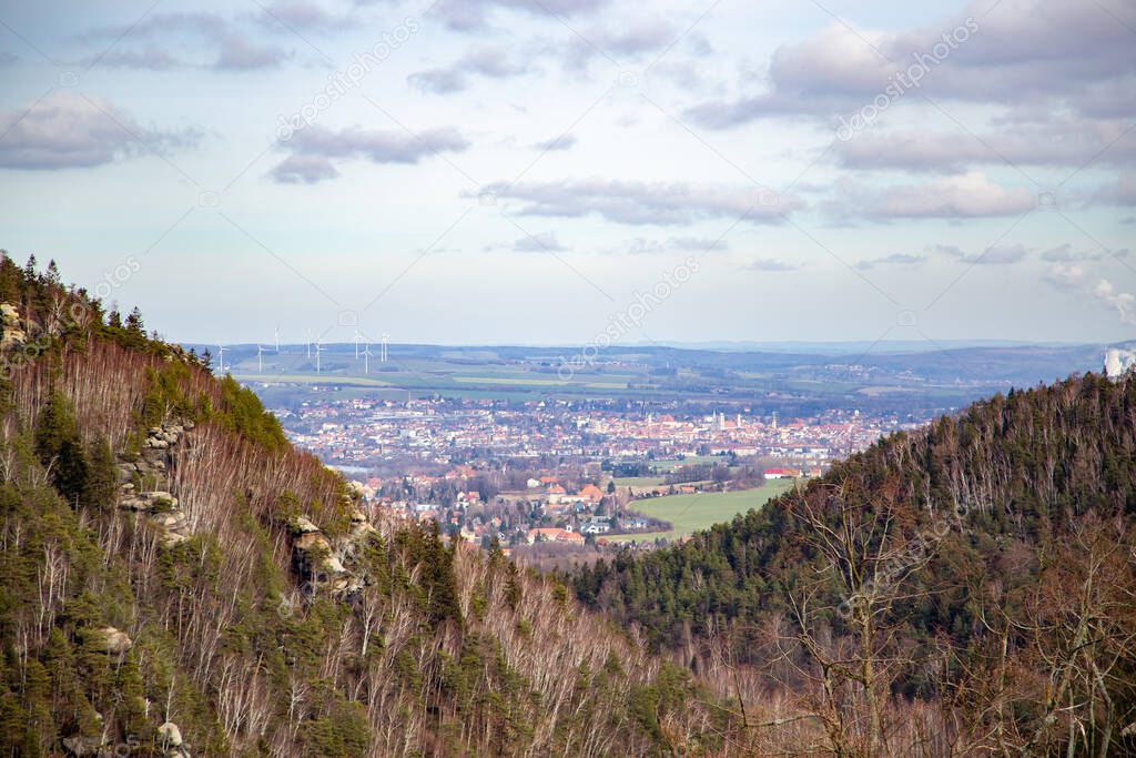 The view into the valley of the Zittau mountains from the castle Oybin to the little village Olbersdorf and at the very back of the valley the town Zittau.