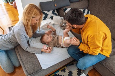 Anne babalar bebek bezi değiştirirler.
