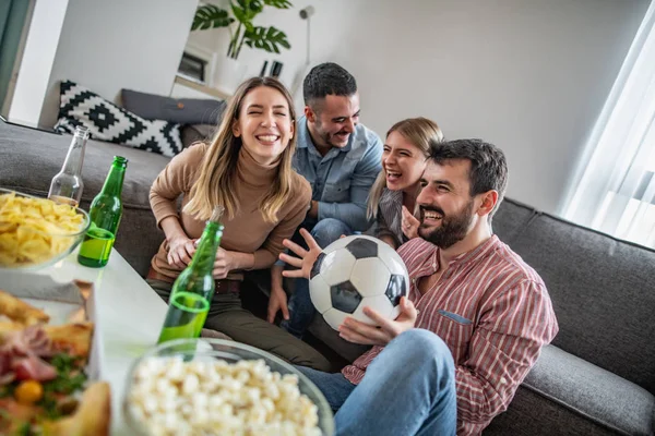 Groep van vrienden die genieten van voetbal op TV — Stockfoto