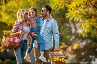 Mutlu aile doğada piknik yapıyor. Gülümseyen aile parkta piknik yapıyor..