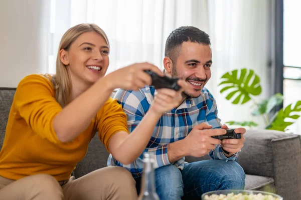 Happy friends playing video games at home.Happiness and gaming concept.