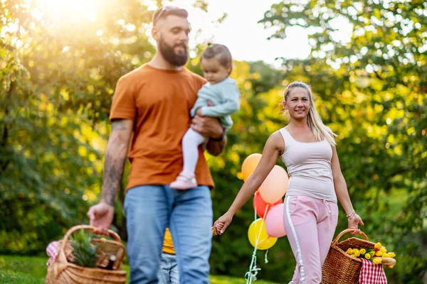 Joyful family picnicking in the park.Family picnicking together.Family on picnic at sunny day.Leisure, holidays, people and love concept.