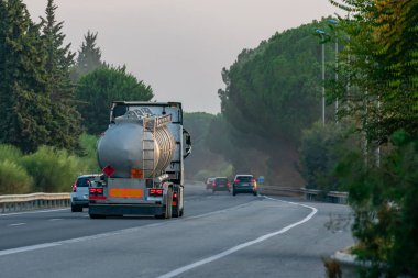 Tank truck of dangerous goods on the road clipart