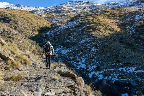 Young man walking on a path in Sierra Nevada, Spain.