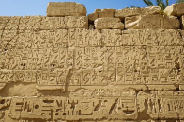 An ancient wall of Egyptian hieroglyphs at the ruins of Karnak Temple in Egypt clipart