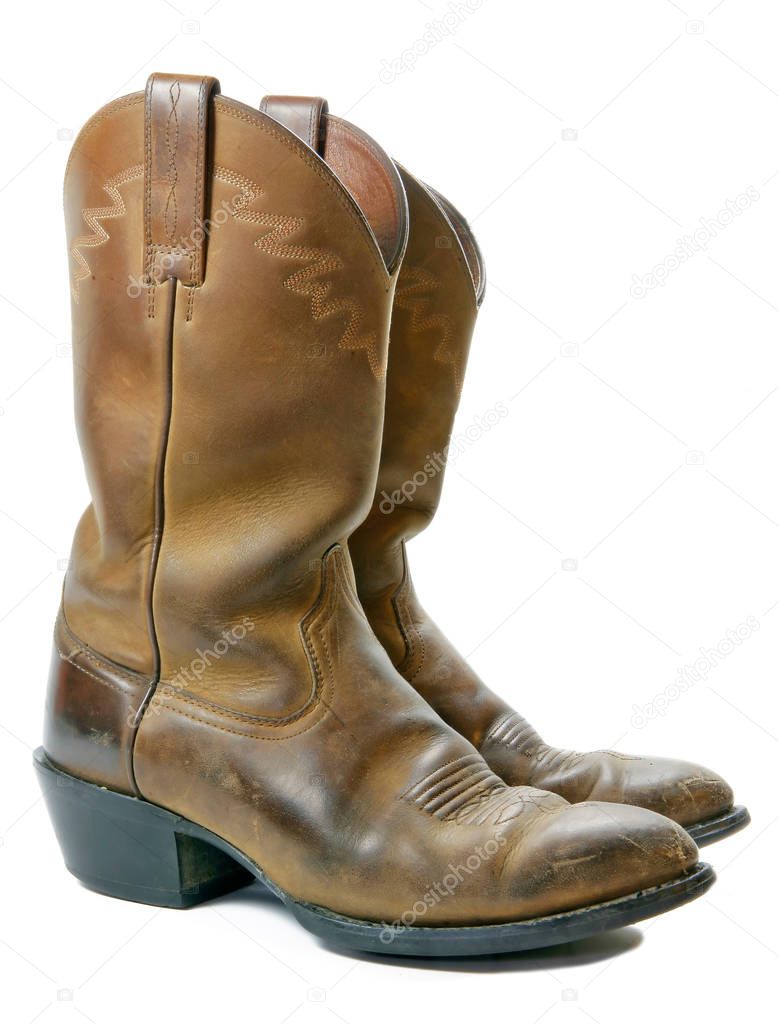 A pair of old leather cowboy boots, isolated on white