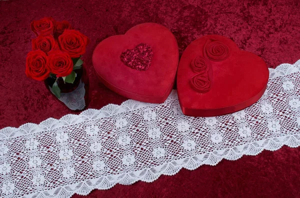Valentines Scene With Heart Shaped Chocolate Box, Bunch of Roses on Red Crushed Velvet Background and White Lace Runner
