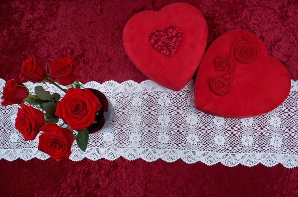 Valentines Scene With Heart Shaped Chocolate Box, Bunch of Roses on Red Crushed Velvet Background and White Lace Runner