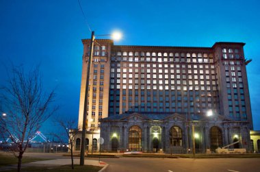 Detroit, Michigan USA, April 5, 2018, Michigan Central Station, MCS, Detroit Old Train Depot, at Night With Lights On in Windows clipart
