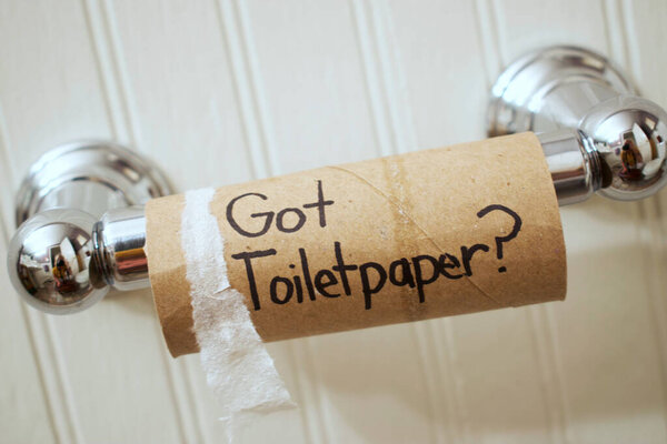 Empty Cardboard Toilet Paper Roll On A Chrome Spool Reading, "Got Toilet Paper?" in Sharpie