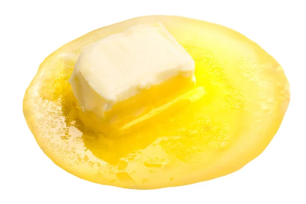 Melted butter piece floating — Stock Photo, Image