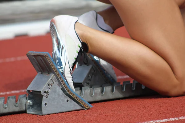 Close-up of feet of an athlete on a starting block about to run