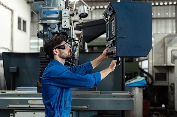 man engineer wearing uniform safety are checking system machine in factory. Workers industrial factory.