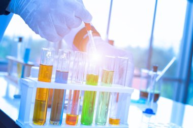 Laboratuarda masada tutucu renkli sıvılarla test tüpleri.