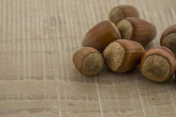 Hazelnuts on a wooden base — Stock Photo, Image