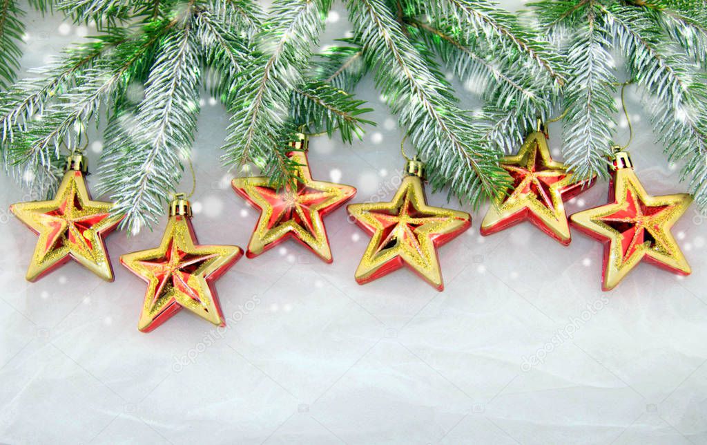 Christmas decoration with green Christmas twigs and shiny stars on a white background