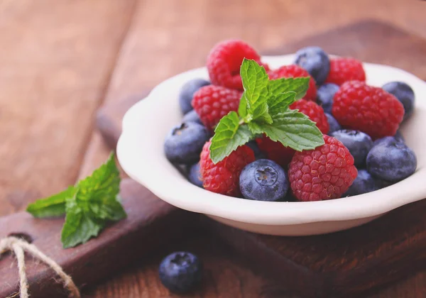 Berries on plate with mint — Stock Photo, Image