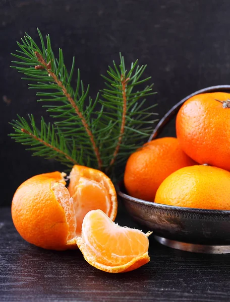 Tangerines in a metal bowl with a branch of a Christmas tree — Stock Photo, Image