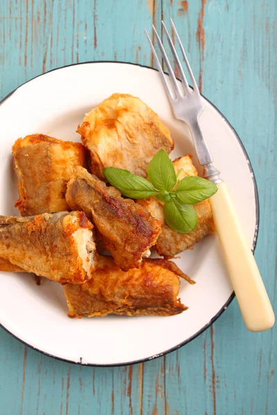 Pescado de merluza frito en un plato blanco — Foto de Stock