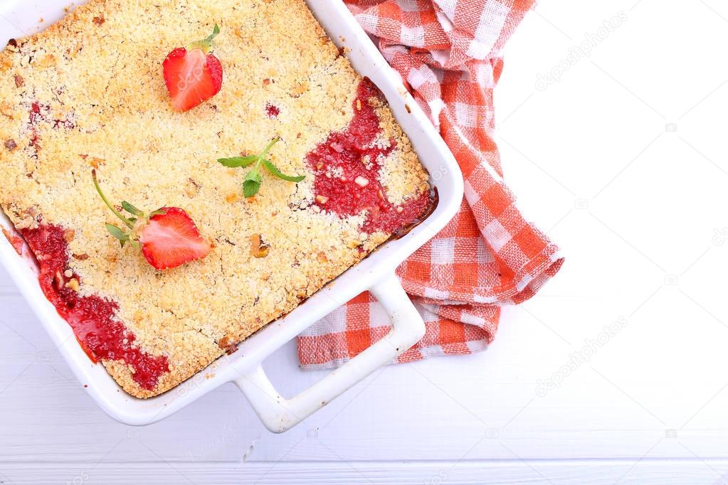 crumble with strawberries in white plate
