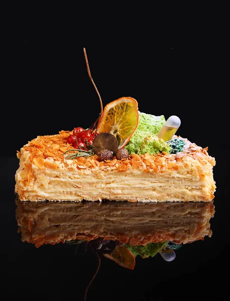 Cake Napoleon on black background, cut