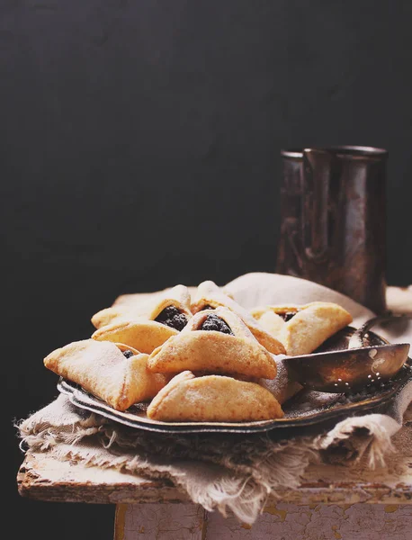 Triangle biscuits with jam served on vintage tray