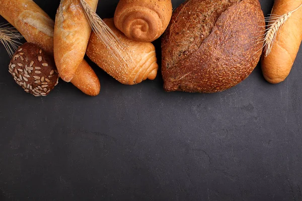 Pile of fancy bread on black stone background