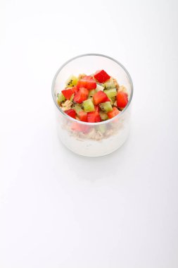 healthy breakfast: yogurt with chia seeds, granola and strawberries on white background