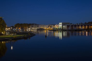 Night shot of northern sea with industrial port and sunset