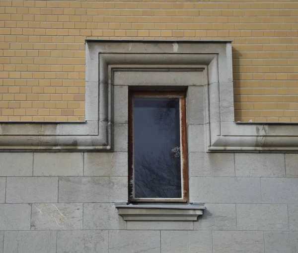 Window, bypass ledge, brick wall and smooth limestone block wall