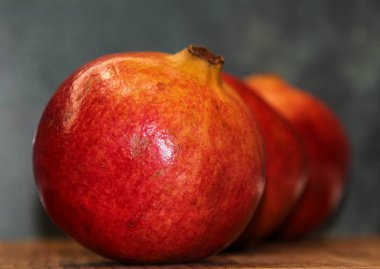  Three large ripe pomegranates in a row