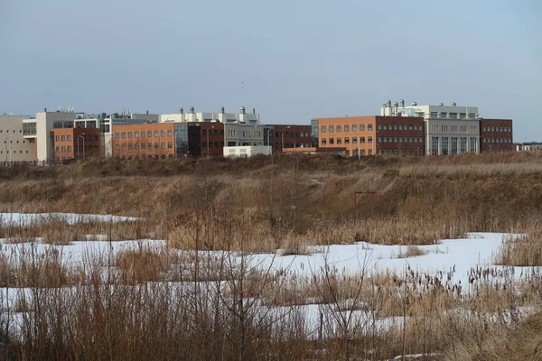 Modern industrial buildings on the background of a frozen pond