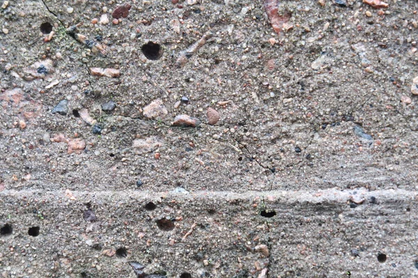 Concrete slab with large cracks and round holes