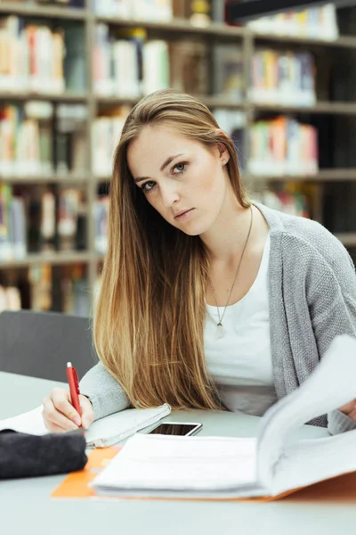 Estudante bonita do sexo feminino com laptop e café aprendizagem em uma biblioteca do ensino médio — Fotografia de Stock