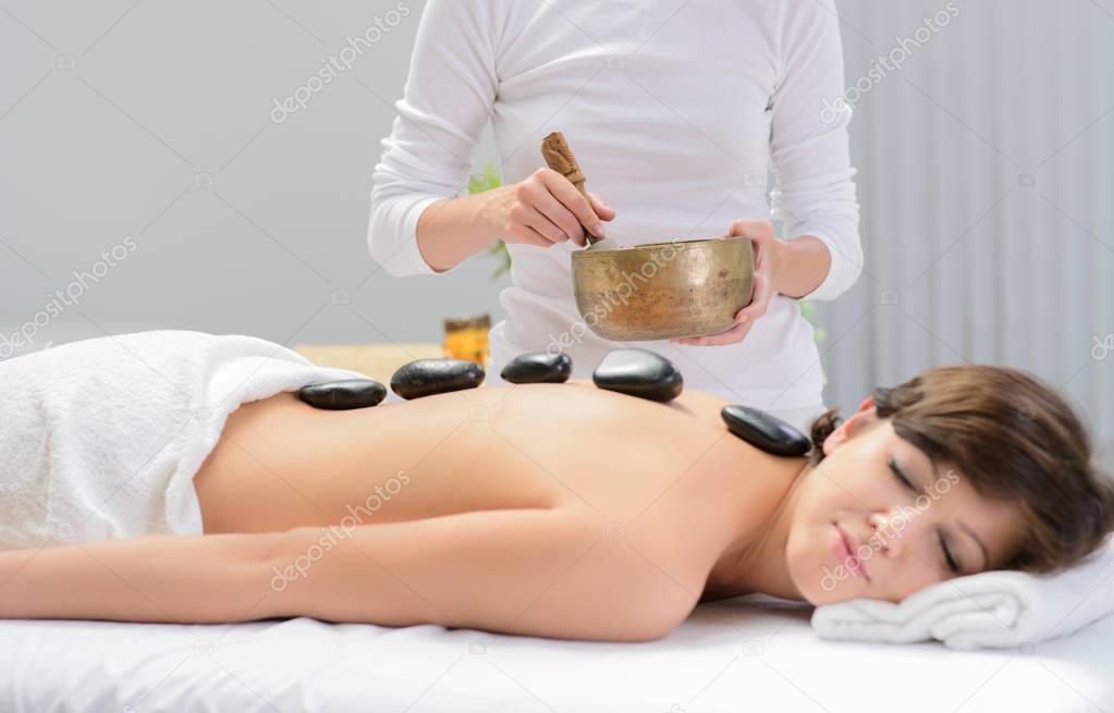 hot stone massage  with sound bowl in spa center