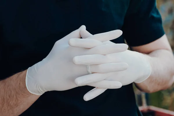 Man wearing gloves for protection from virus