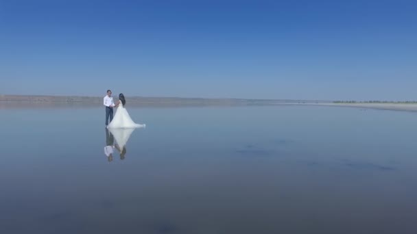 Bride Groom Reflected Water Young Wedding Couple Standing Middle Sea — Stock Video