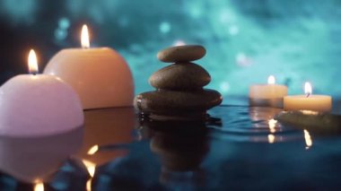 Spa Still Life, Stones masajı ve Su Rahatlaması. Kapatın. Yanan mumların rahatlatıcı görüntüsü. Bulanık arka planda su yansıması. Rahatlama, sakinlik, meditasyon, huzur ve sessizlik.