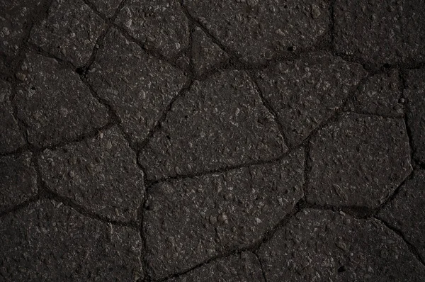 Macro close-up em rachaduras de asfalto de concreto na estrada — Fotografia de Stock
